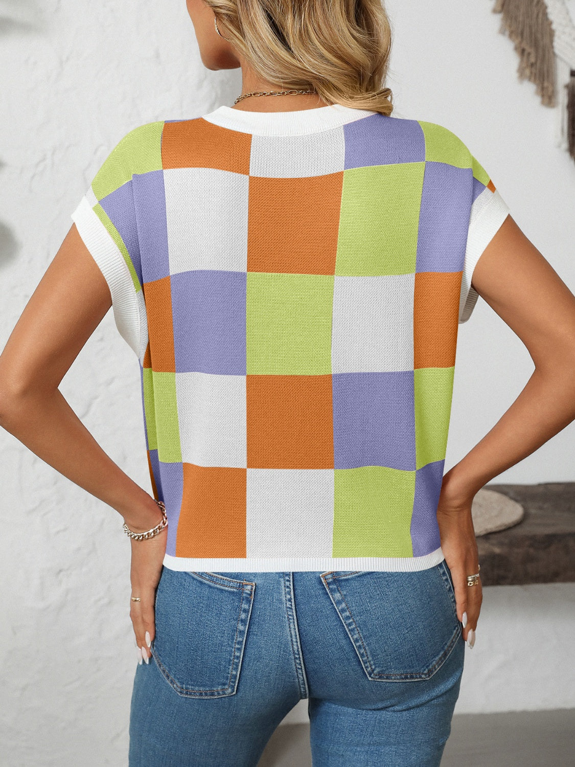 Checkerboard knit cap sleeve top in blue purple, pink orange, and blue green with white squares.
