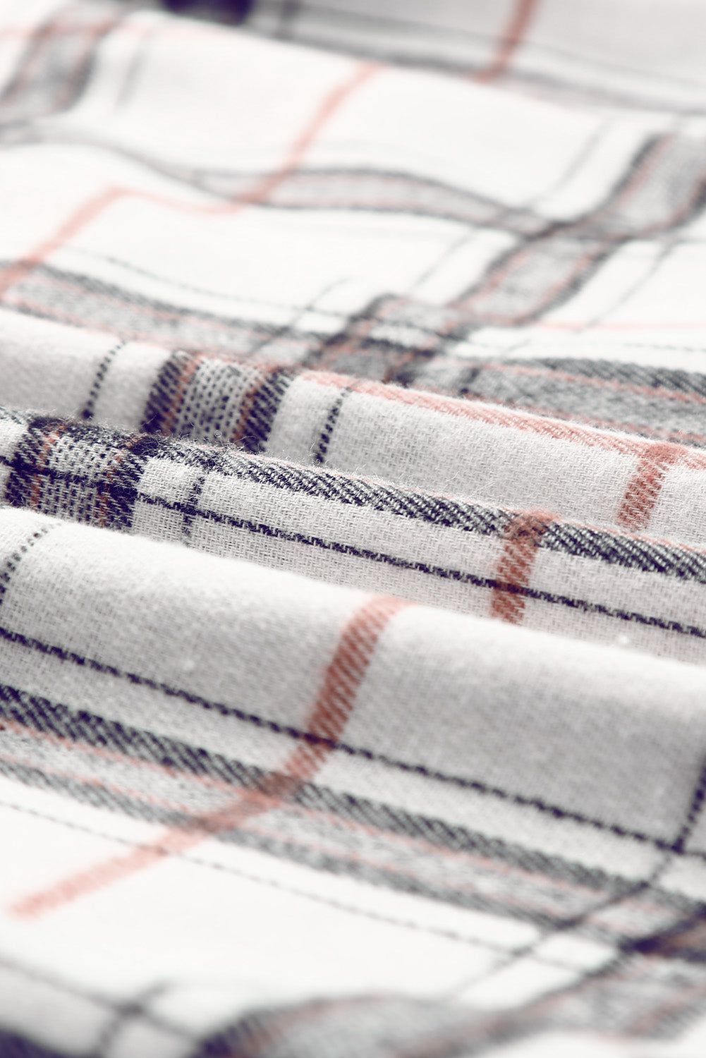 Oversized white shacket with plaid pattern in black and rust.