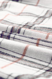 Oversized white shacket with plaid pattern in black and rust.
