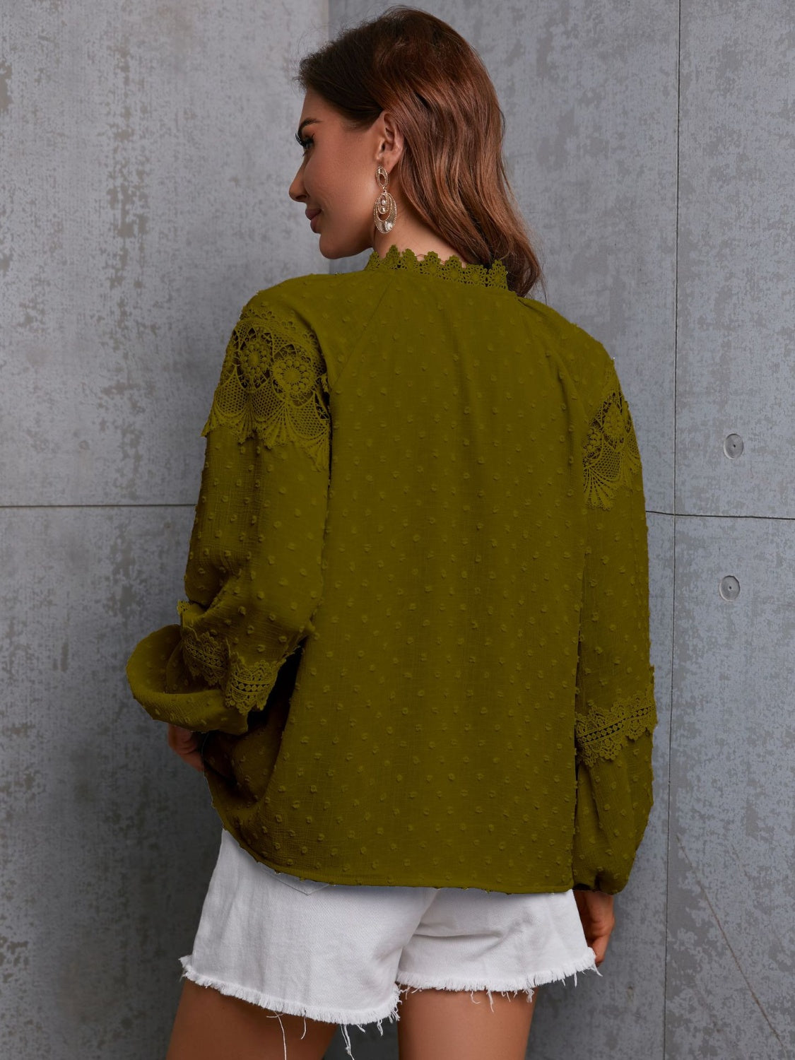 Moss textured blouse with lace trim on neckline and sleeves, tie neck detail.
