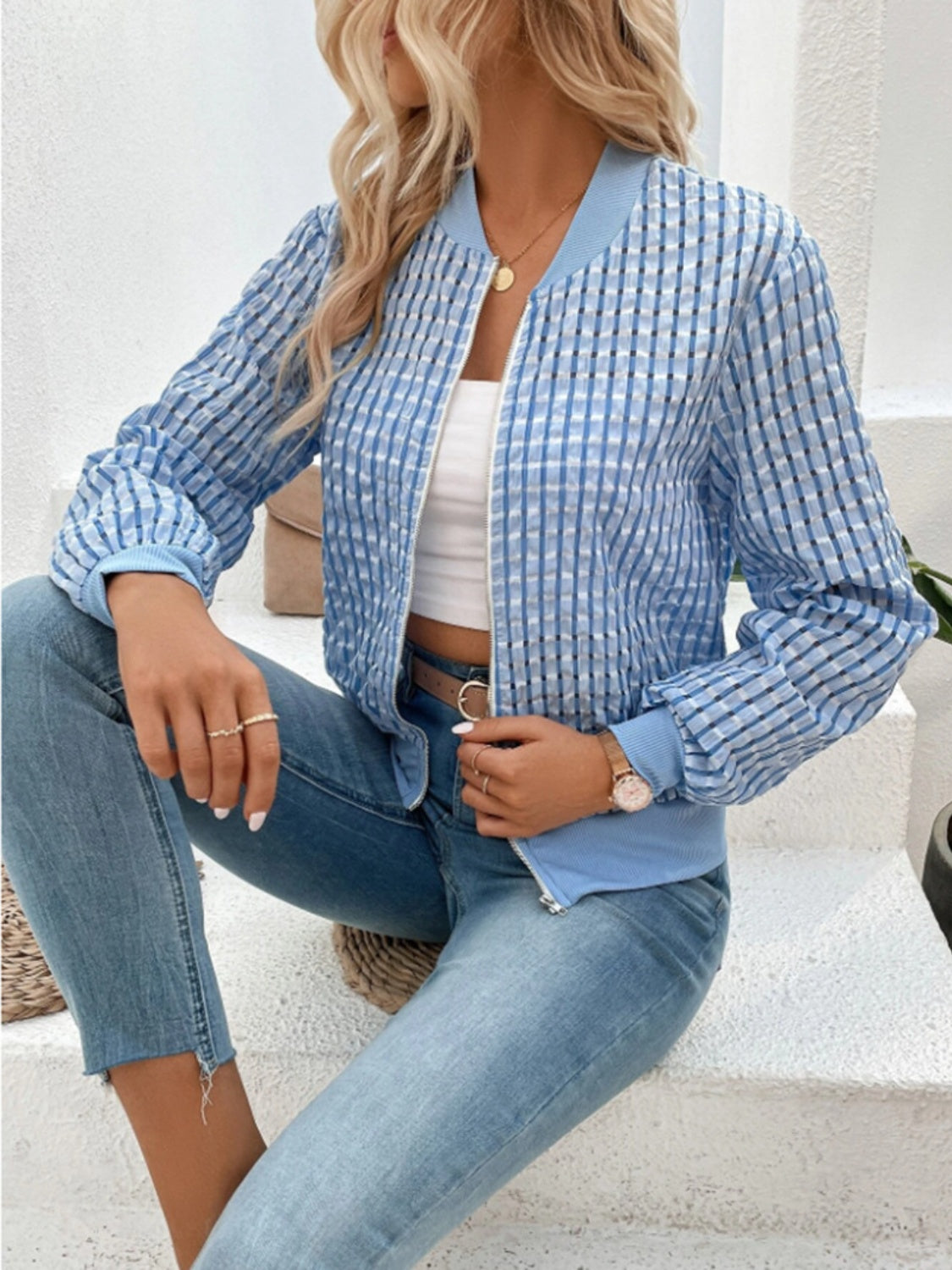 Light blue bomber jacket with textured mesh and checkered pattern.