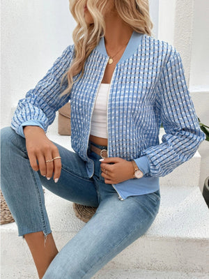 Light blue bomber jacket with textured mesh and checkered pattern.
