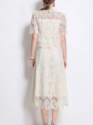 Ivory lace two-piece dress with short sleeves and midi skirt, featuring intricate paisley pattern.