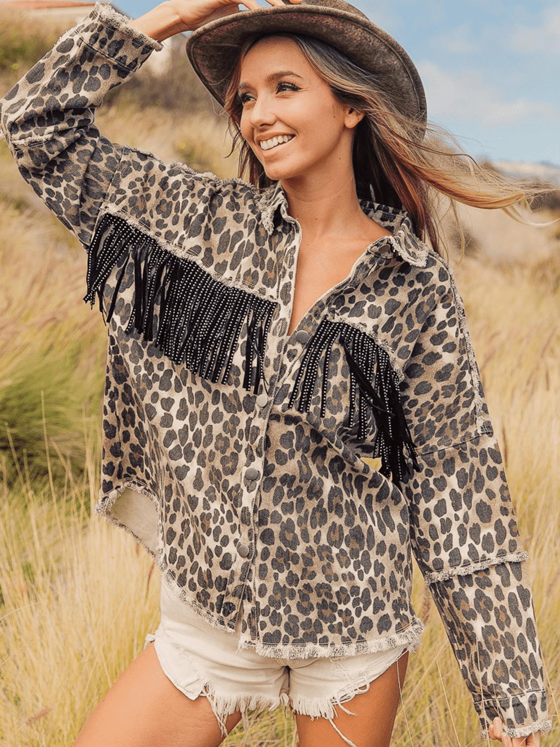 Leopard print denim jacket with fringe and bead embellishments, collared neck, cotton.