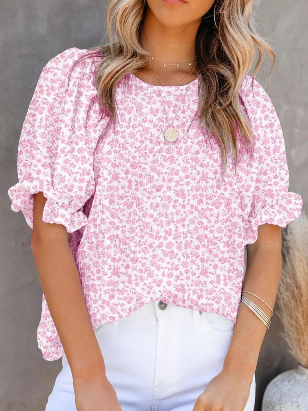 Pink floral print maternity blouse with smocked bodice and ruffle sleeves.