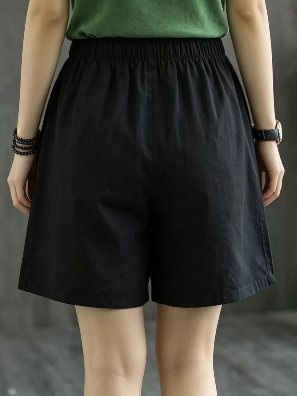 Black chino shorts with elastic waist and relaxed fit.