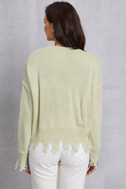 Light Yellow knit sweater with distressed hem and cuffs.