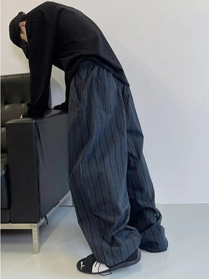 Men's dark grey striped wide-leg sweatpants with pockets.