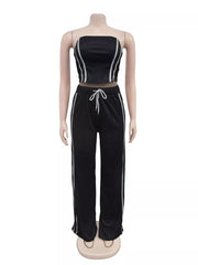 Black tube top and wide-leg pant set with white stripe detail and drawstring waist.