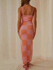 Geometric knit maxi slip dress in pink and orange checkerboard pattern with spaghetti straps.