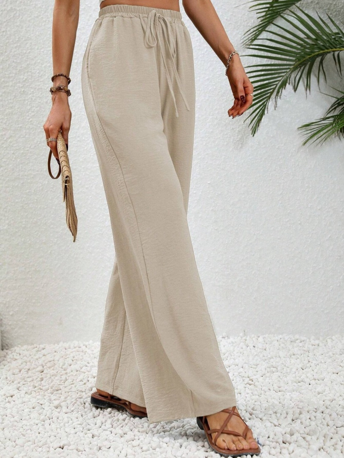 Textured palazzo trousers in cream with a drawstring waist and wide leg