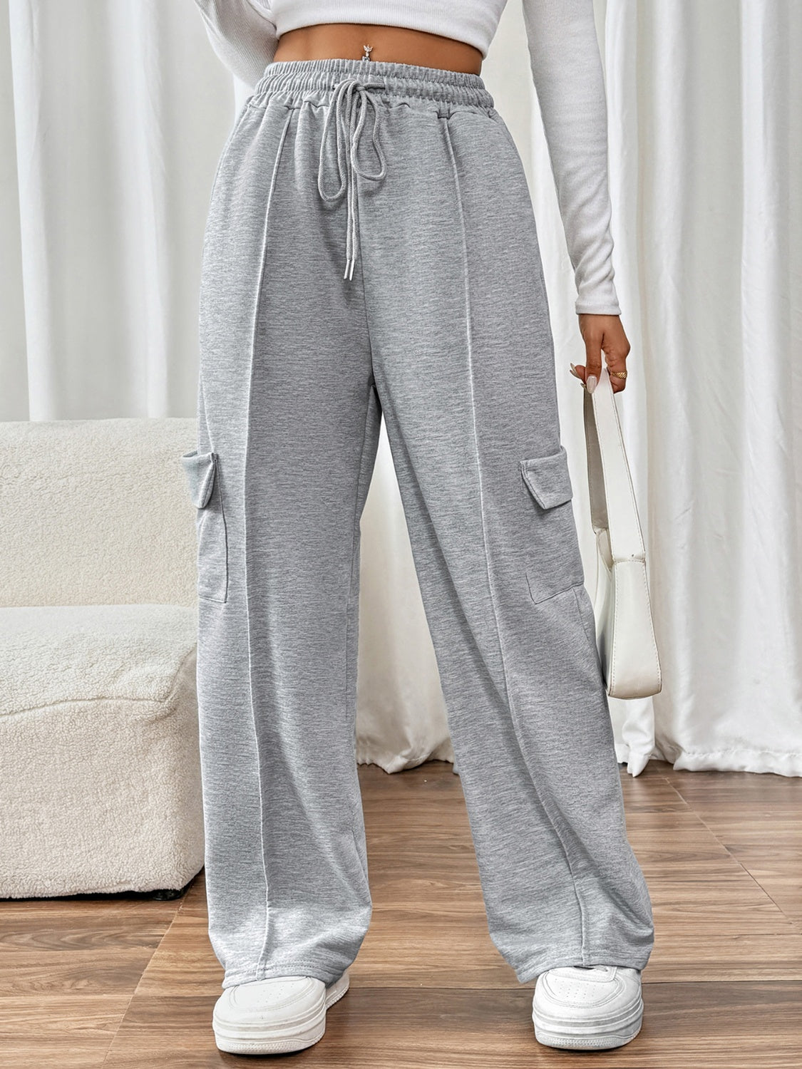 Gray cargo pocket wide leg sweatpants with drawstring waist and pockets.