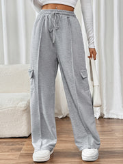 Gray cargo pocket wide leg sweatpants with drawstring waist and pockets.