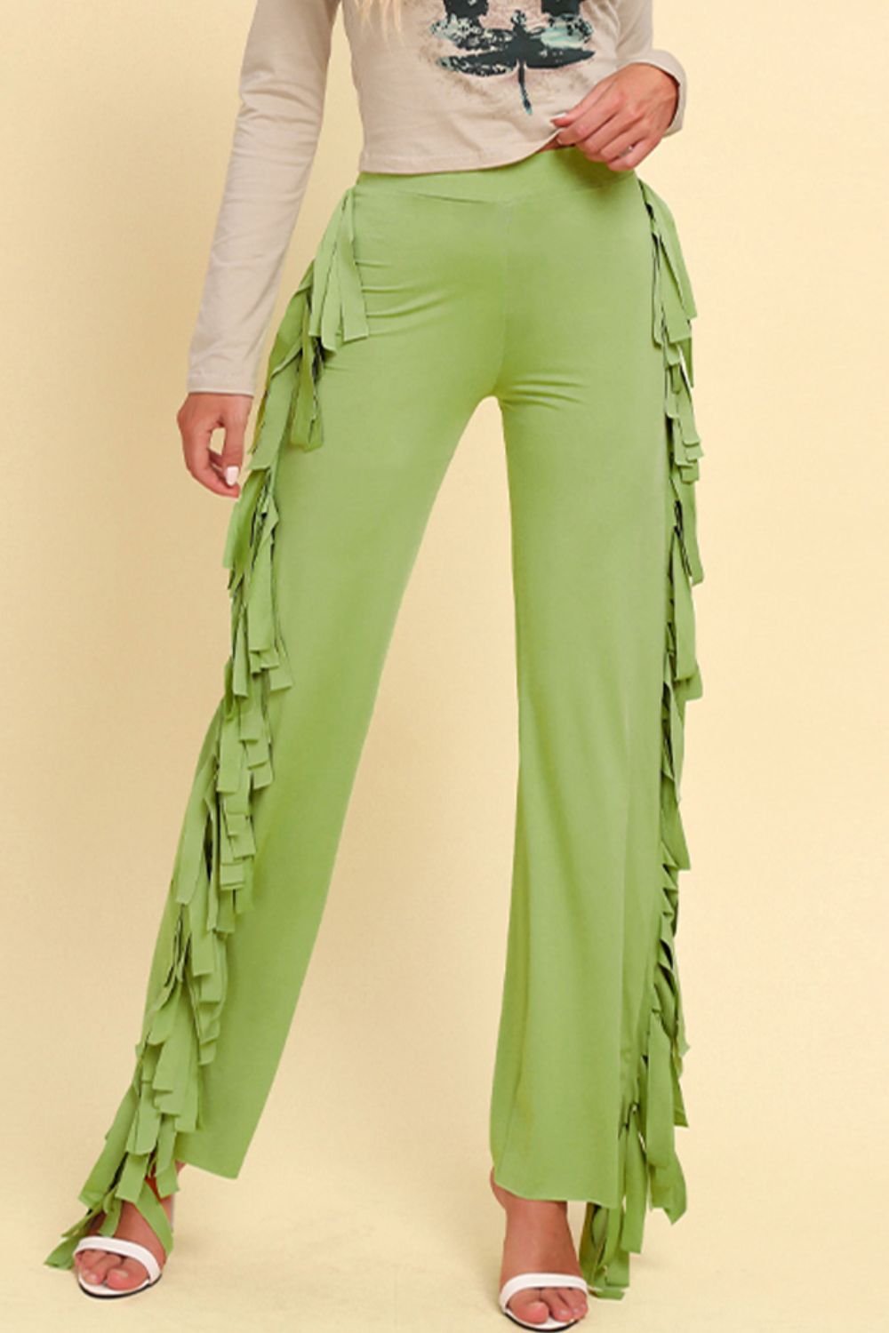 Yellow-green palazzo trousers with cascading fringe detail on the sides.