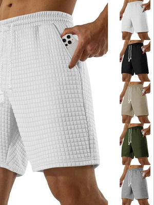 Waffle knit relaxed fit shorts with drawstring and pockets in white.