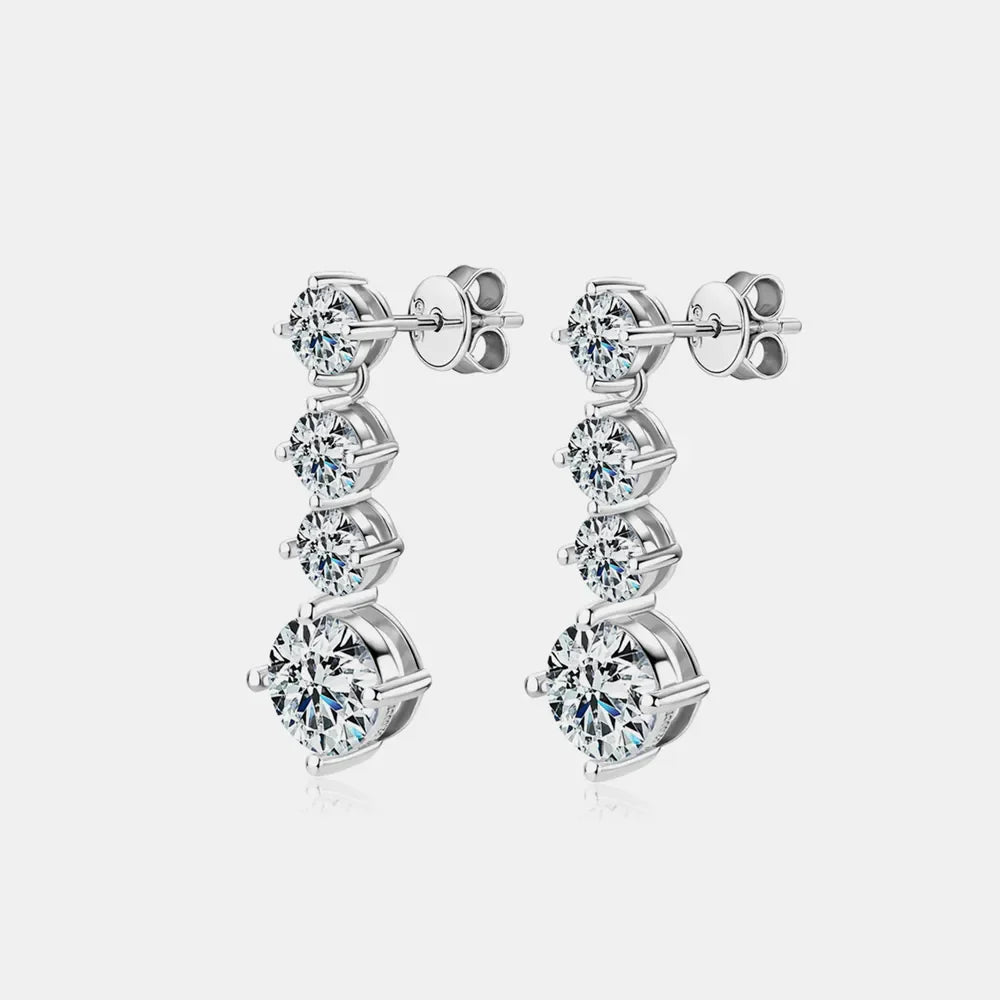 Silver cascade cubic zirconia drop earrings with three round stones each.