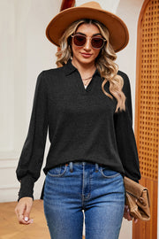 Black buttoned blouse with collared neckline and lantern sleeves