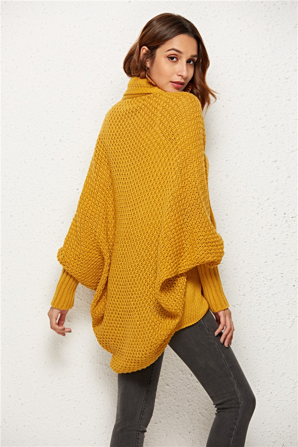 Textured cocoon knit cardigan in gold with batwing sleeves and a turtleneck.