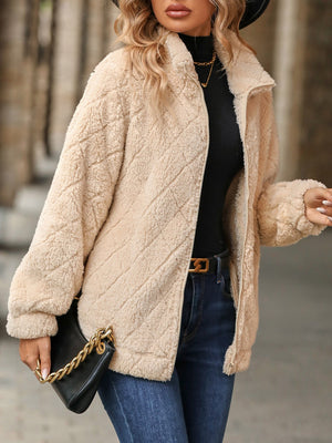 Textured teddy zip-up jacket in tan with diamond quilting and a stand-up collar.