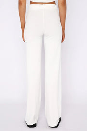 White ribbed wide leg pants with a high waist, shown from the back.