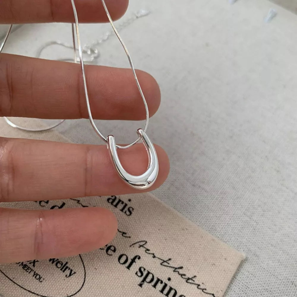 Sterling silver U-shaped pendant necklace with delicate snake chain.
