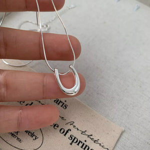 Sterling silver U-shaped pendant necklace with delicate snake chain.