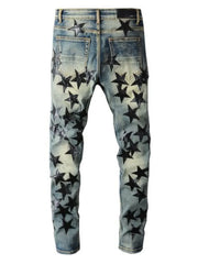 Slim-fit denim jeans in medium wash with all-over black star appliqués.