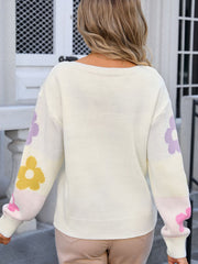 Ivory knit pullover sweater with floral print on sleeves, crew neck, long sleeves.