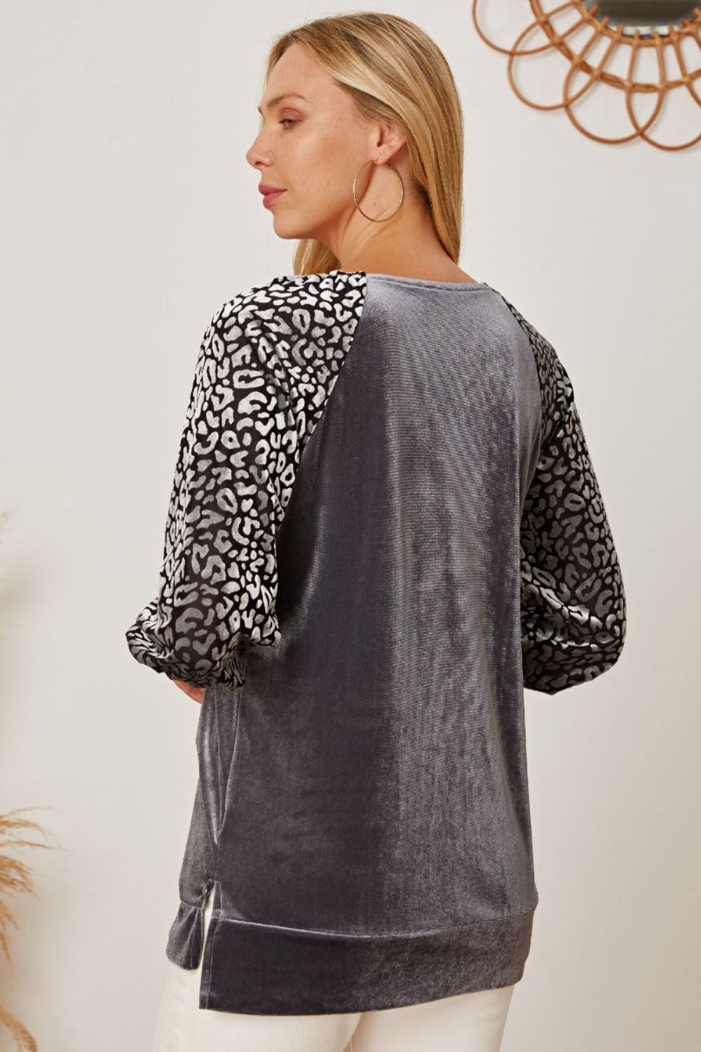 Velvet raglan top in dark gray with black and white leopard print sleeves.
