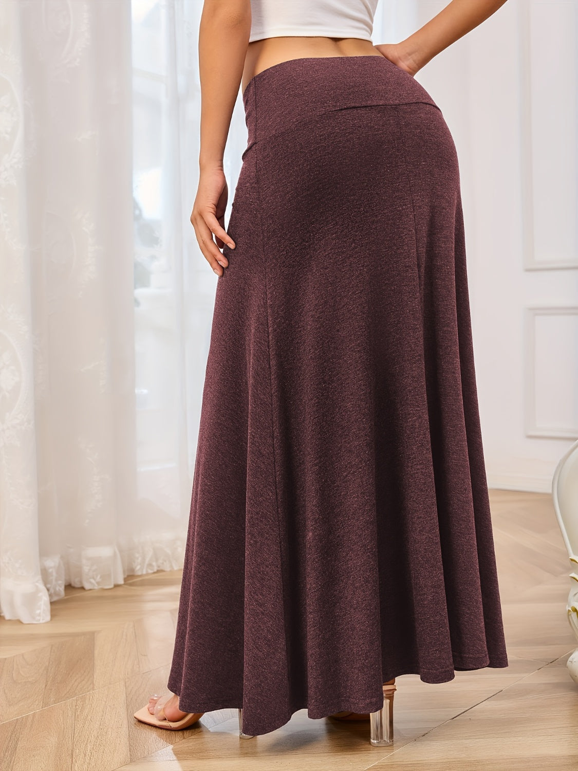 Flowing jersey maxi skirt in burgundy with a high waist and A-line cut.