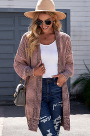 Pink textured puff sleeve open cardigan with a subtle pattern, styled with a white top and jeans.