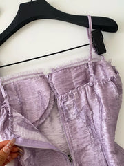 Purple lace ruffle hem tank top with ruched texture and zipper detail.