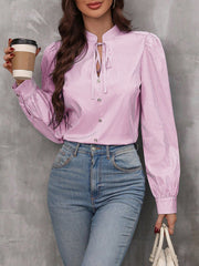 Pink striped blouse with puffed sleeves and keyhole neckline, button front detail
