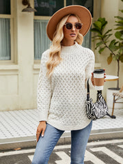 White textured diamond knit turtleneck sweater with long sleeves and a relaxed fit.