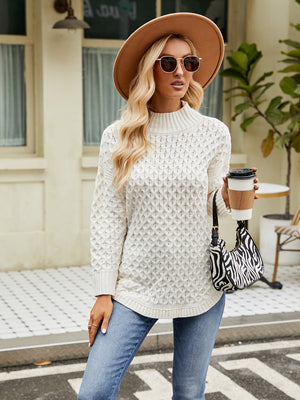 White textured diamond knit turtleneck sweater with long sleeves and a relaxed fit.