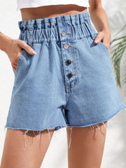 High-waisted denim paperbag shorts in medium wash with button fly and frayed hem.
