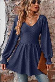 Dark blue textured blouse with V-neck, empire waist, and shirred bell sleeves.