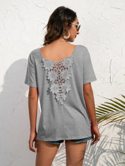 Grey t-shirt with floral lace back detail and short sleeves.