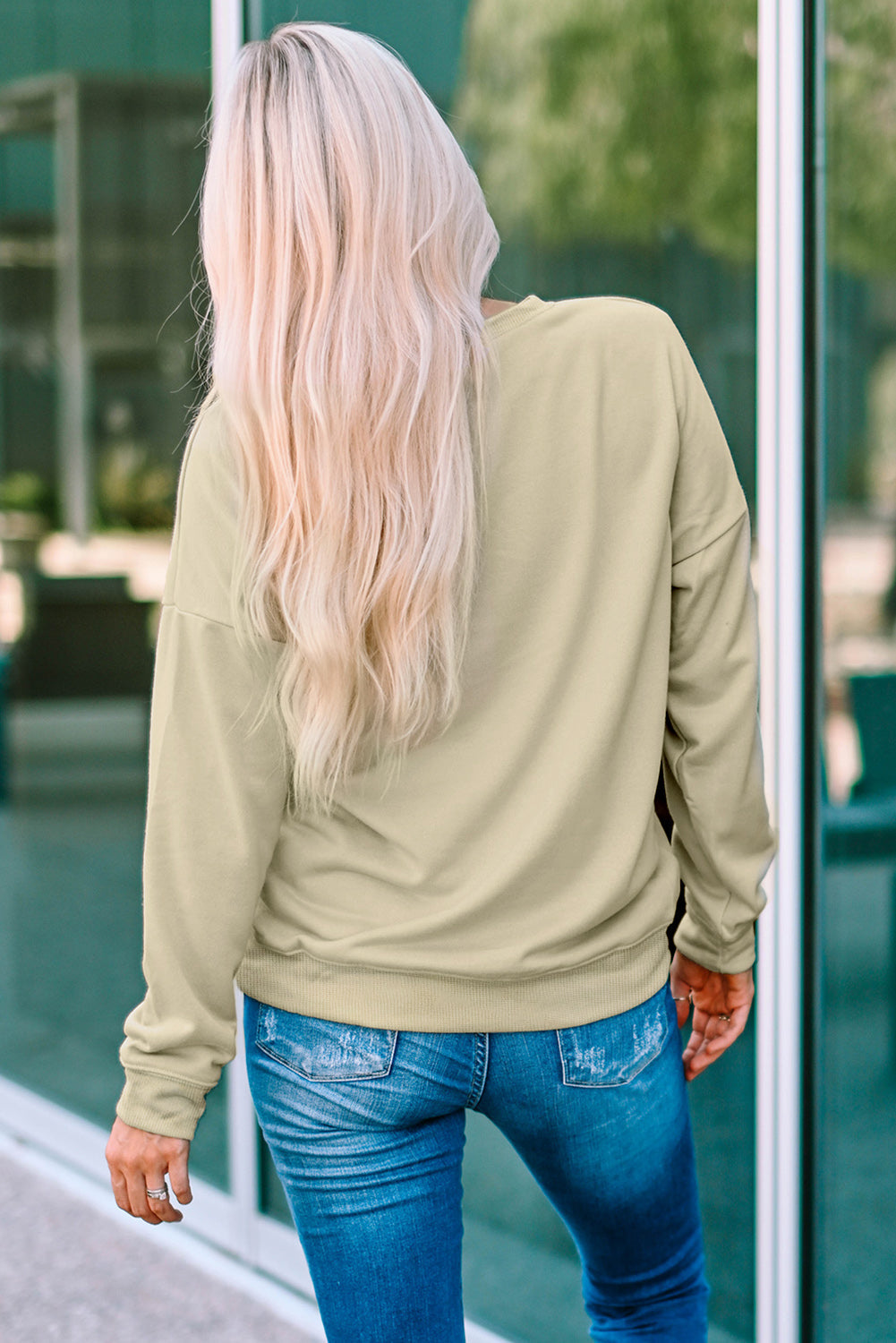 Khaki crewneck sweatshirt with leopard graphic detail on front, casual long sleeve style.