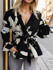 Black and white brushstroke wrap blouse with lace trim and tie waist