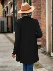 Black asymmetrical drape front cardigan with long sleeves.