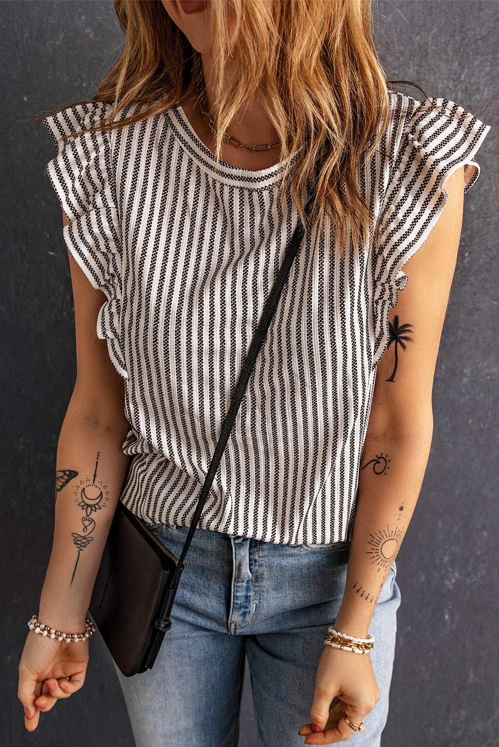 Textured stripe cap sleeve top with ruffled edges in black and white.