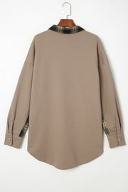 Tan waffle knit overshirt with plaid trim on collar and cuffs, button front.