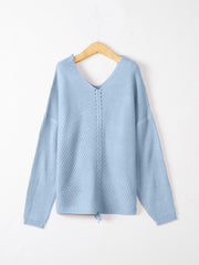 Pastel blue slouchy knit sweater with V-neck and lace-up detail at hem