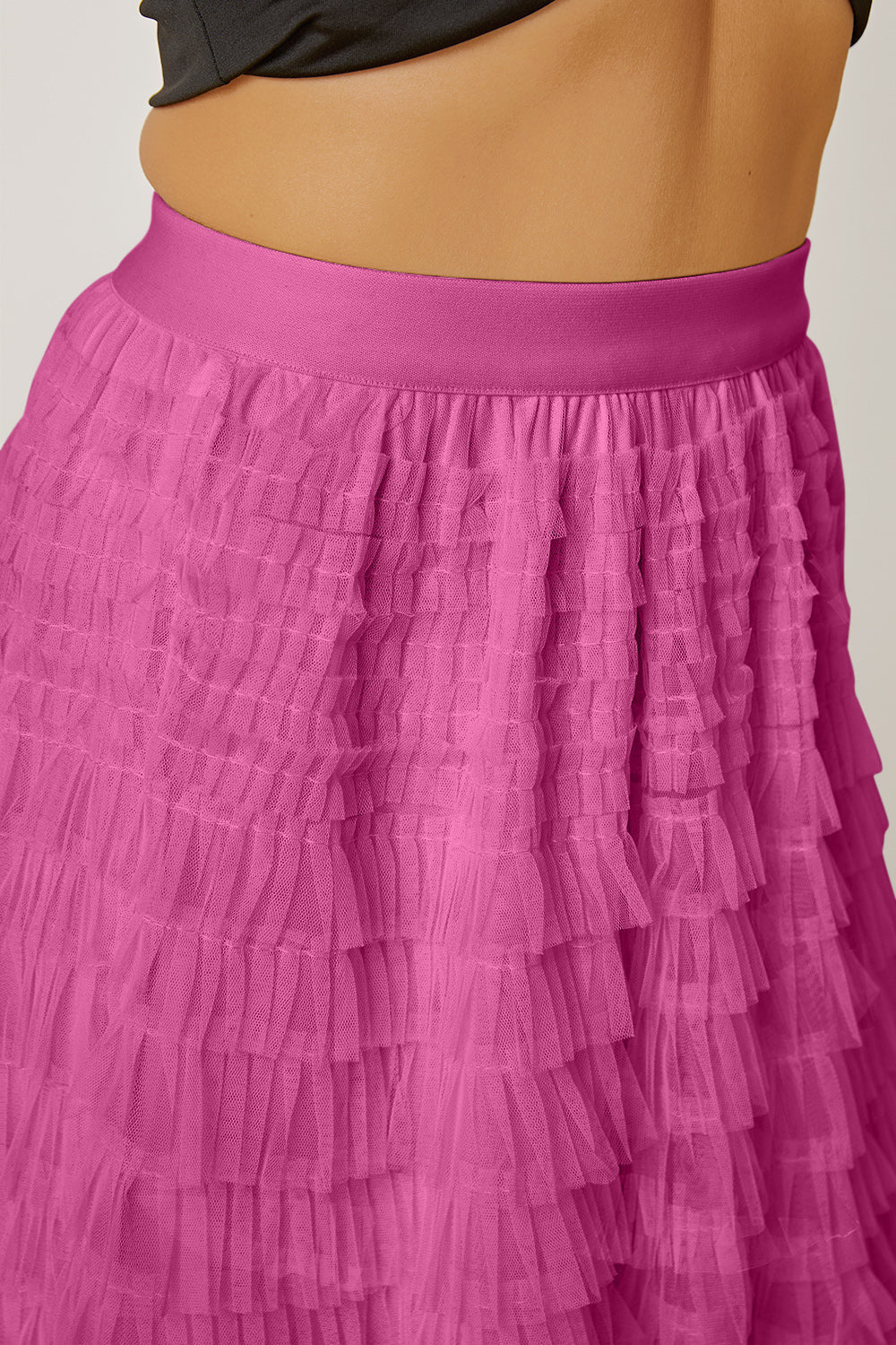 Pink tiered tulle maxi skirt with ruffled layers and a satin waistband.