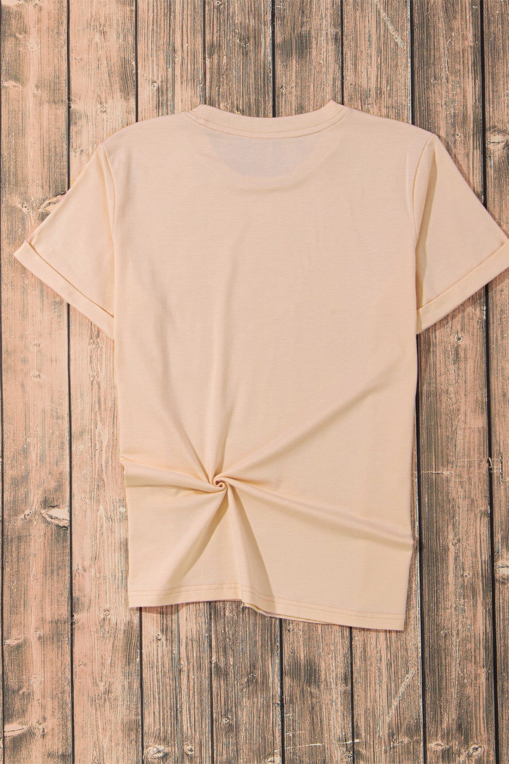 Tan t-shirt with rolled sleeves and a knotted hem detail.