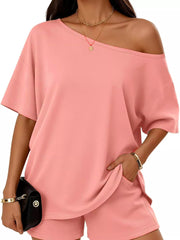 Pink asymmetrical one-shoulder set with pockets and short sleeves.