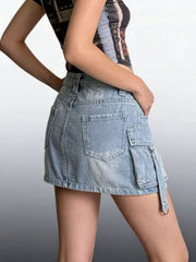 Plus size light wash denim cargo skirt with button closure and utility pockets.
