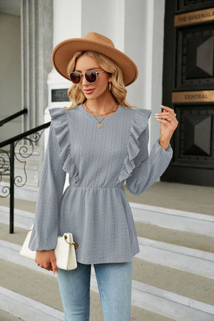 Textured ruffle peplum blouse in Cloudy Blue with long sleeves and round neckline.