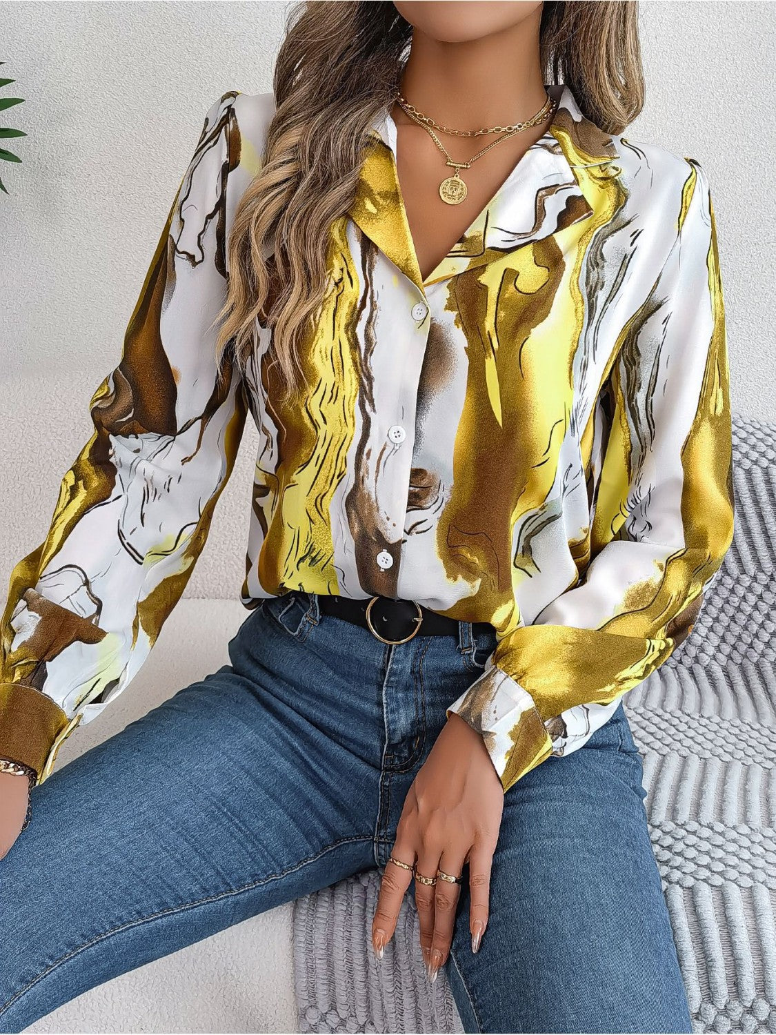 Women's abstract swirl print silk blouse in yellow and white with button front and collar.